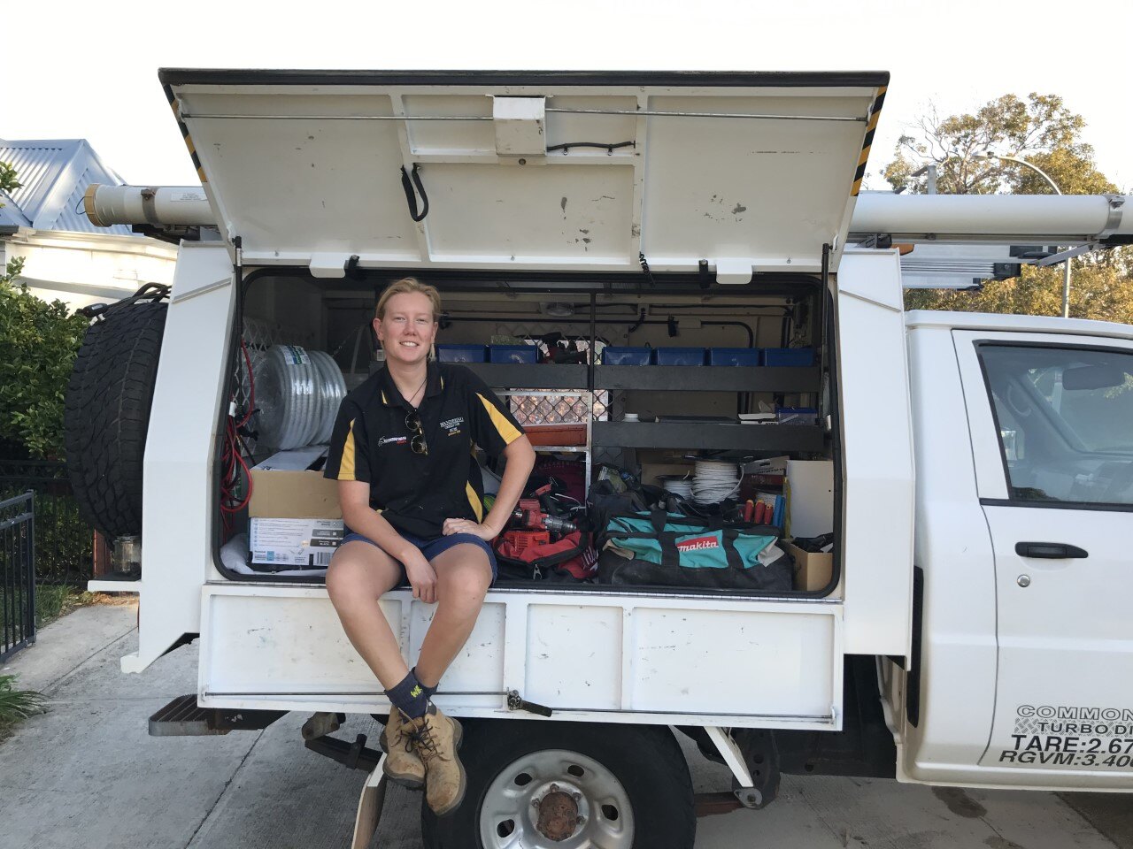 Rosey sitting at the Roseys Electrical work ute