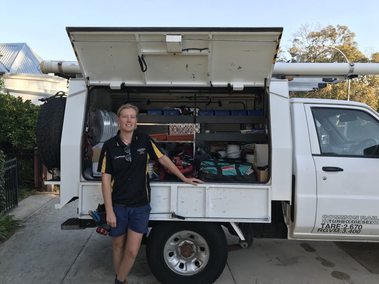Rosey beside the fully equipped electrical work ute